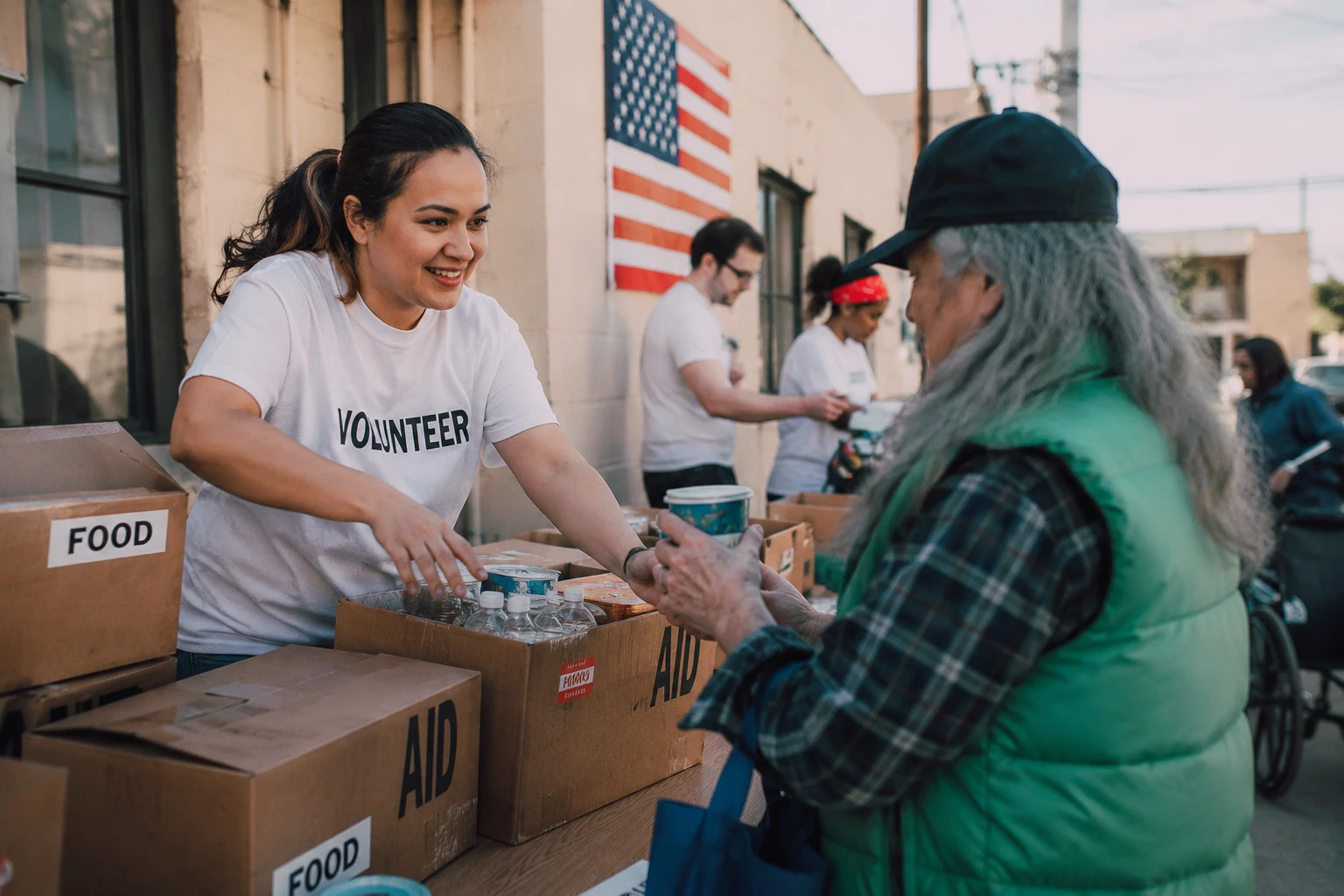 Volunteer handing food at an outdoor aid table